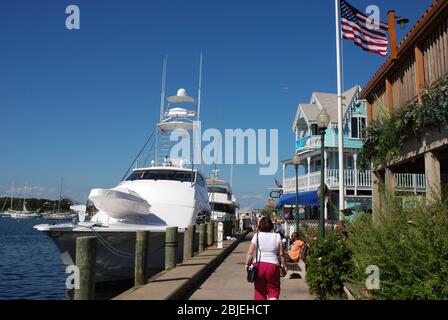 Oaks Bluff, Martha's Vineyard, MA, USA - September 2008:  Person walking along the harbor with a super yacht berthed alongside Stock Photo