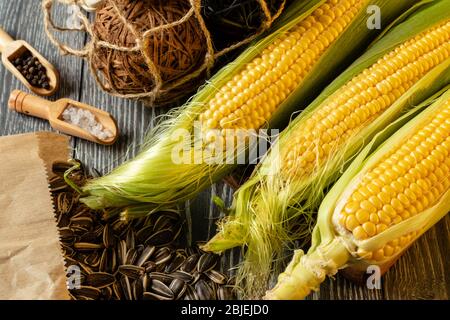 Fresh corn on cobs on rustic wooden table, closeup Stock Photo