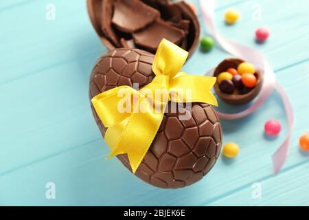 Chocolate Easter eggs on color wooden background Stock Photo