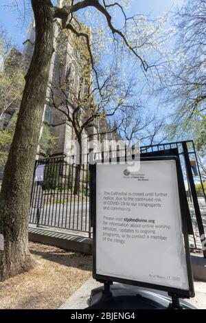 sign in front of the Cathedral of St. John the Divine stating it is closed due to the coronavirus or covid-19 pandemic Stock Photo