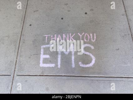 thank you ems written in chalk on a sidewalk a spontaneous sign of appreciation to emergency medical services  or ems workers Stock Photo