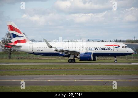 Glasgow, UK. 28 April 2020.   Pictured: A British Airways flight from London Heathrow arrives in Glasgow, which is one of only a handful of scheduled flights into Glasgow today during the Coronavirus (COVID-19) crisis UK extended lockdown.  To date British Airways has made an announcement which sees almost 12,000 staff axed reacting to the pandemic which has hit every major airline, putting some out of business. Credit: Colin Fisher/Alamy Live News. Stock Photo