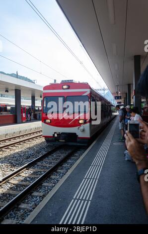 Matterhorn Gotthard Bahn railcar arriving at Visp station in Switzerland Stock Photo