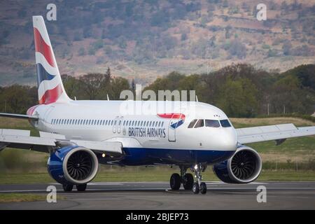 Glasgow, UK. 28 April 2020.   Pictured: A British Airways flight from London Heathrow arrives in Glasgow, which is one of only a handful of scheduled flights into Glasgow today during the Coronavirus (COVID-19) crisis UK extended lockdown.  To date British Airways has made an announcement which sees almost 12,000 staff axed reacting to the pandemic which has hit every major airline, putting some out of business. Credit: Colin Fisher/Alamy Live News. Stock Photo