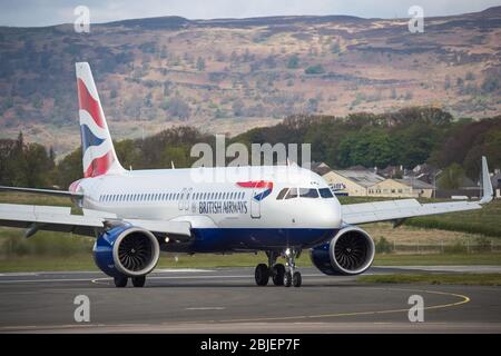 Glasgow, UK. 28 April 2020.   Pictured: A British Airways flight from London Heathrow arrives in Glasgow, which is one of only a handful of scheduled flights into Glasgow today during the Coronavirus (COVID-19) crisis UK extended lockdown.  To date British Airways has made an announcement which sees almost 12,000 staff axed reacting to the pandemic which has hit every major airline, putting some out of business. Credit: Colin Fisher/Alamy Live News. Stock Photo