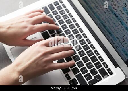 Programmer using laptop, closeup Stock Photo
