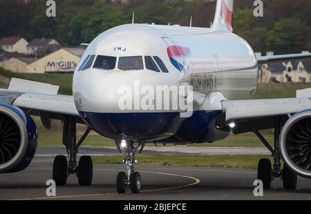 Glasgow, UK. 28 April 2020.   Pictured: A British Airways flight from London Heathrow arrives in Glasgow, which is one of only a handful of scheduled flights into Glasgow today during the Coronavirus (COVID-19) crisis UK extended lockdown.  To date British Airways has made an announcement which sees almost 12,000 staff axed reacting to the pandemic which has hit every major airline, putting some out of business. Credit: Colin Fisher/Alamy Live News. Stock Photo