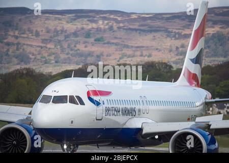 Glasgow, UK. 28 April 2020.   Pictured: A British Airways flight from London Heathrow arrives in Glasgow, which is one of only a handful of scheduled flights into Glasgow today during the Coronavirus (COVID-19) crisis UK extended lockdown.  To date British Airways has made an announcement which sees almost 12,000 staff axed reacting to the pandemic which has hit every major airline, putting some out of business. Credit: Colin Fisher/Alamy Live News. Stock Photo