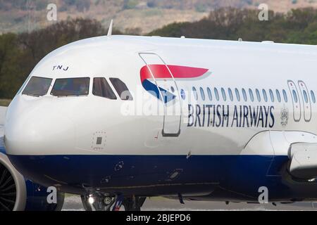 Glasgow, UK. 28 April 2020.   Pictured: A British Airways flight from London Heathrow arrives in Glasgow, which is one of only a handful of scheduled flights into Glasgow today during the Coronavirus (COVID-19) crisis UK extended lockdown.  To date British Airways has made an announcement which sees almost 12,000 staff axed reacting to the pandemic which has hit every major airline, putting some out of business. Credit: Colin Fisher/Alamy Live News. Stock Photo