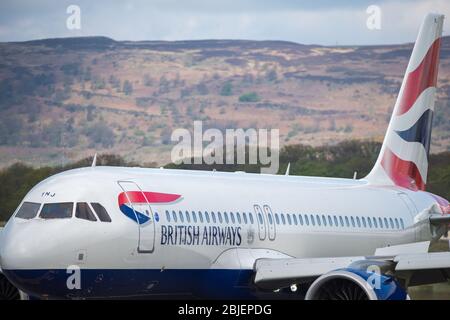 Glasgow, UK. 28 April 2020.   Pictured: A British Airways flight from London Heathrow arrives in Glasgow, which is one of only a handful of scheduled flights into Glasgow today during the Coronavirus (COVID-19) crisis UK extended lockdown.  To date British Airways has made an announcement which sees almost 12,000 staff axed reacting to the pandemic which has hit every major airline, putting some out of business. Credit: Colin Fisher/Alamy Live News. Stock Photo