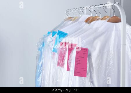 https://l450v.alamy.com/450v/2bjepfp/rack-of-clean-clothes-hanging-on-hangers-at-dry-cleaning-2bjepfp.jpg