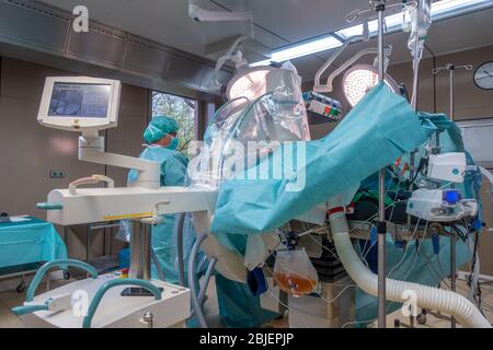 in an operating theatre, a hip prosthesis operation is performed by two doctors Stock Photo