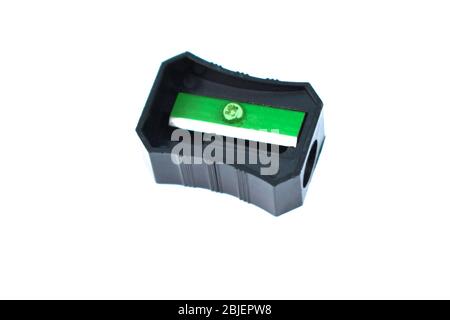 Black color plastic pencil sharpener placed on top of a white isolated background Stock Photo