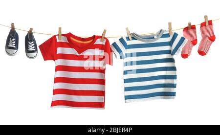 Baby clothes hanging on white background Stock Photo