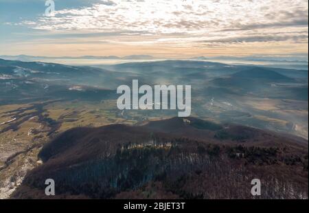 Aerial view of Carpathian Mountains with fog in Romania at sunset Stock Photo