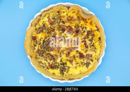 Home-baked Quiche Lorraine. The dish is made with cheese, eggs, cream and bacon and baked in pastry. Stock Photo
