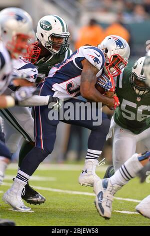October 20, 2013: New England Patriots running back Brandon Bolden (38) is stopped by New York Jets outside linebacker Quinton Coples (98) and New Yor Stock Photo