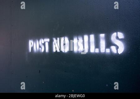 Post No Bills spray painted on green plywood around a contrution sight Stock Photo