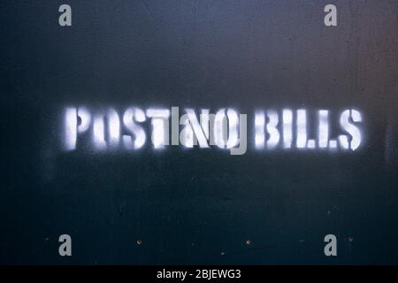 Post No Bills spray painted on green plywood around a contrution sight Stock Photo