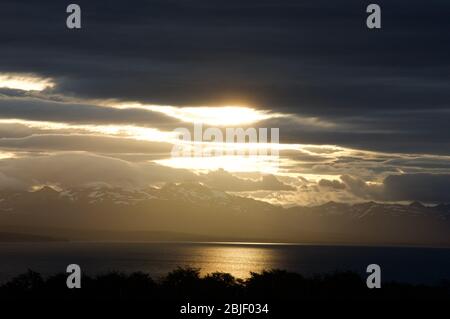 An incredible sunset from Tolhuin (Tierra del Fuego, Argentina), the sun goes down over Fagnano lake. Stock Photo