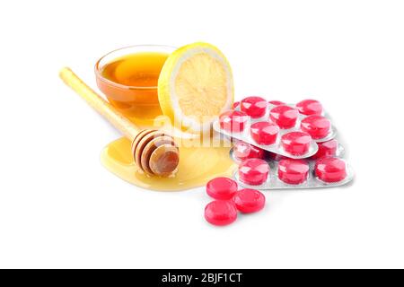 Cough drops with honey and lemon on white background Stock Photo