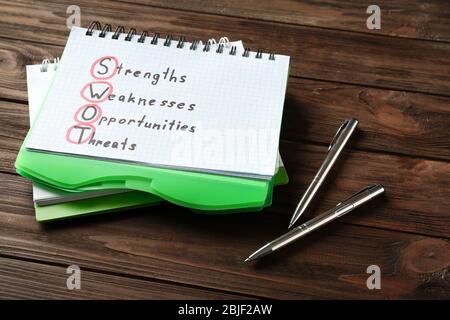 Management concept. Notepad and pens on wooden table Stock Photo