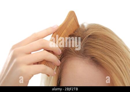 Young woman brushing hair, closeup Stock Photo