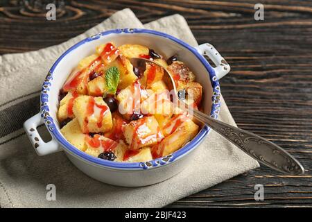 Delicious bread pudding with currant and jam in bowl Stock Photo