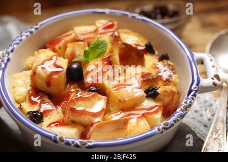 Delicious bread pudding with currant and jam in bowl Stock Photo