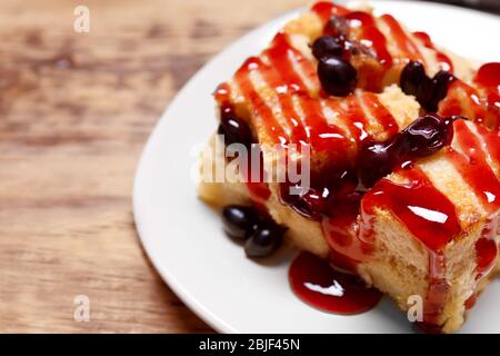 Delicious bread pudding with currant and jam on plate Stock Photo