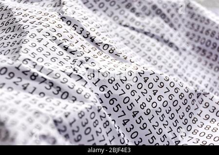 Background with black printed random monospace numbers on crumpled white paper for use as a template for a financial report. Stock Photo