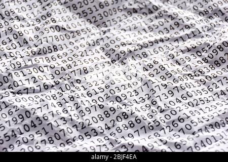 Background with black printed random monospace numbers on crumpled white paper for use as a template for a financial report. Stock Photo