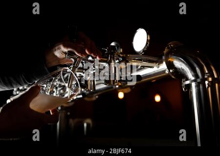 Beer tap in bar, mock up with selective focus. Hand of bartender pouring a beer in tap. Pouring beer for client. Stock Photo