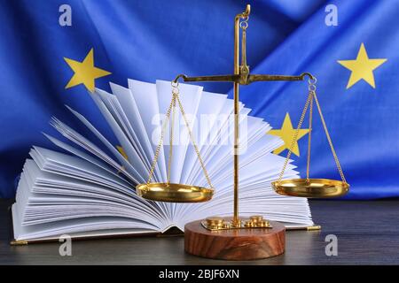 Scales and book on European Union flag background Stock Photo