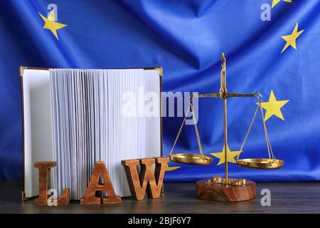 Justice scales and book on European Union flag background Stock Photo
