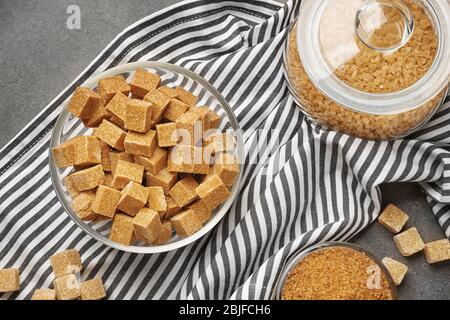 Brown sugar in dishware on napkin Stock Photo