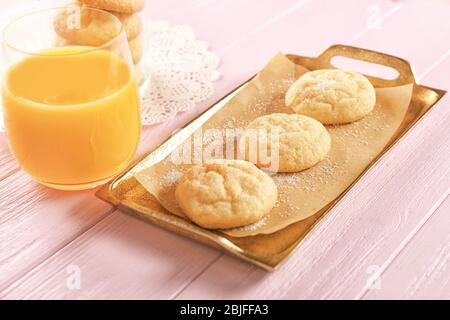 Tray with tasty sugar cookies and glass of juice on wooden background Stock Photo