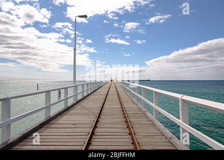 Looking out toward the Indian Ocean on the Busselton Jetty on a sunny day Stock Photo