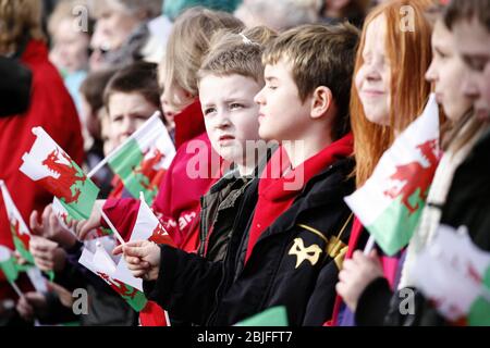 Welsh Guards, Ystradgynlais, Powys, Wales. Primary school children wave flags at the Freedom Parade of the Welsh Gurards in Powys Ystardgynlais which Stock Photo