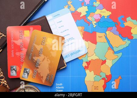 Credit cards with passports and ticket for vacations on world map background Stock Photo