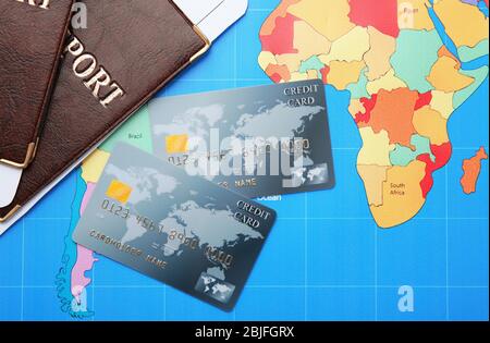 Credit cards with passports and tickets for vacations on world map background Stock Photo