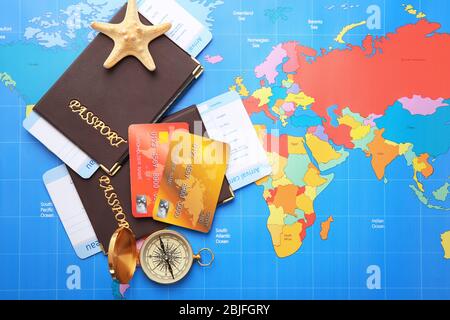 Credit cards with passports and tickets for vacations on world map background Stock Photo