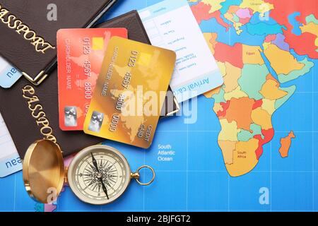 Credit cards with passports and tickets for vacations on world map background Stock Photo