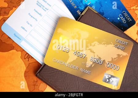 Credit cards with passport and ticket for vacations on world map background, closeup Stock Photo