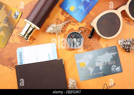 Credit cards with passport and ticket for vacation on world map background Stock Photo