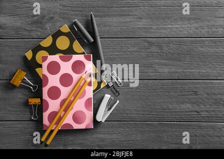 Notebooks and different stationery on wooden background Stock Photo