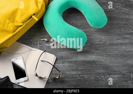 Travel pillow and things for traveling on wooden background Stock Photo