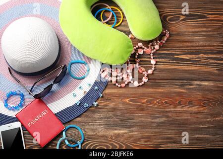 Travel pillow and things for traveling on wooden background Stock Photo