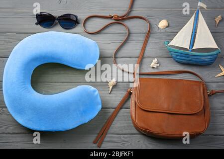 Travel pillow and things for traveling on wooden background Stock Photo