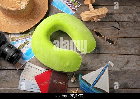 Travel pillow and things for traveling on wooden background Stock Photo